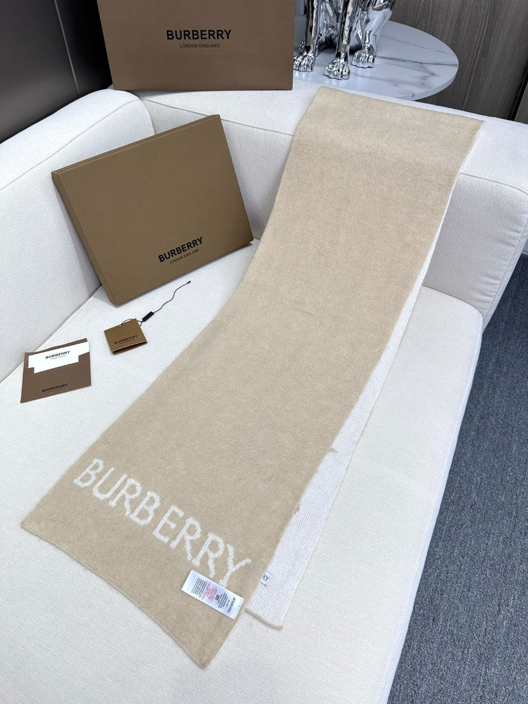 Burberry reversible two-tone wool scarf featuring a circular logo design, crafted from a cotton-wool blend