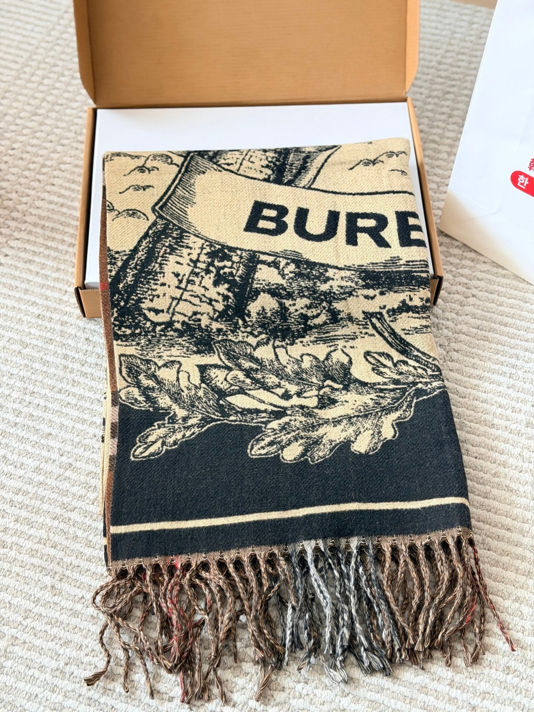 Burberry reversible two-tone wool scarf featuring a circular logo design, crafted from a cotton-wool blend