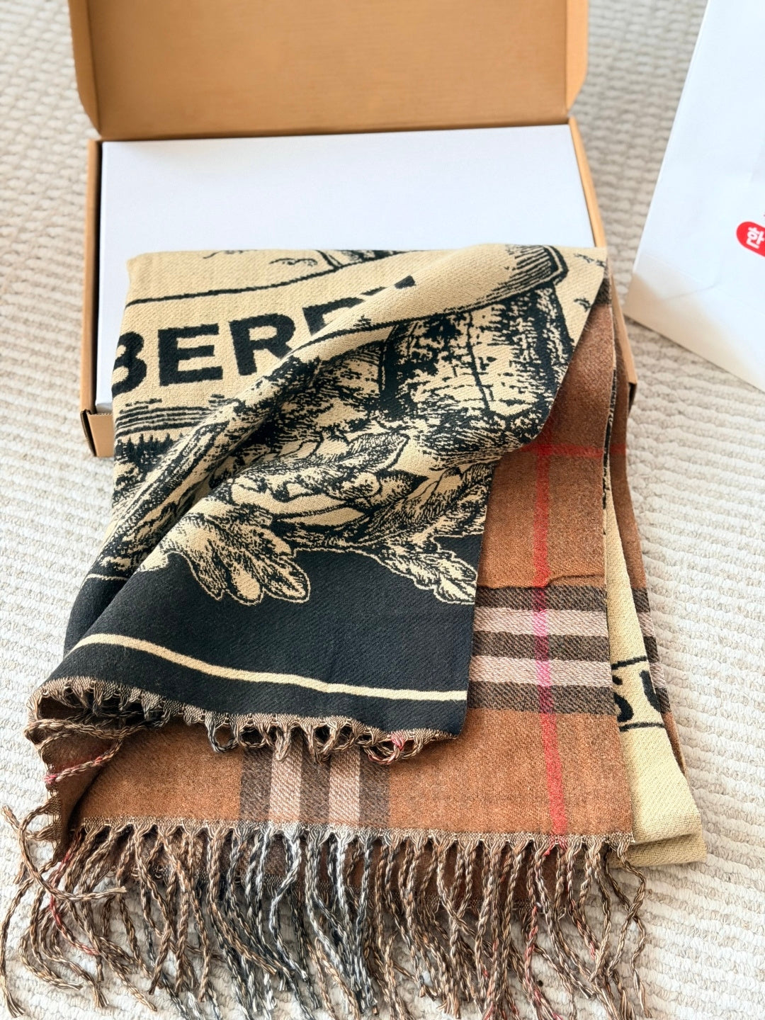 Burberry reversible two-tone wool scarf featuring a circular logo design, crafted from a cotton-wool blend