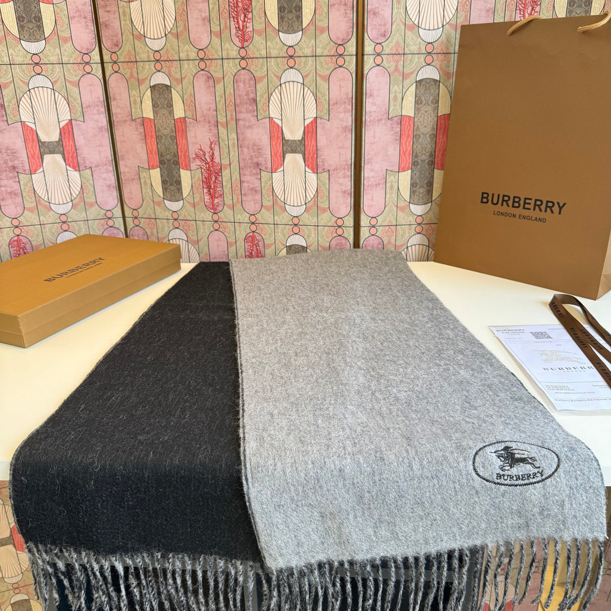 Burberry reversible two-tone wool scarf featuring a circular logo design, crafted from a cotton-wool blend
