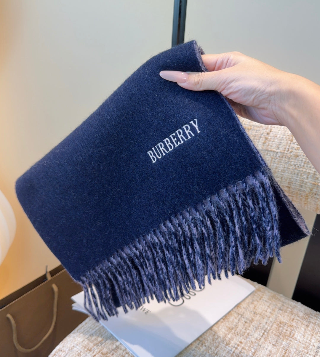 Burberry reversible two-tone wool scarf featuring a circular logo design, crafted from a cotton-wool blend