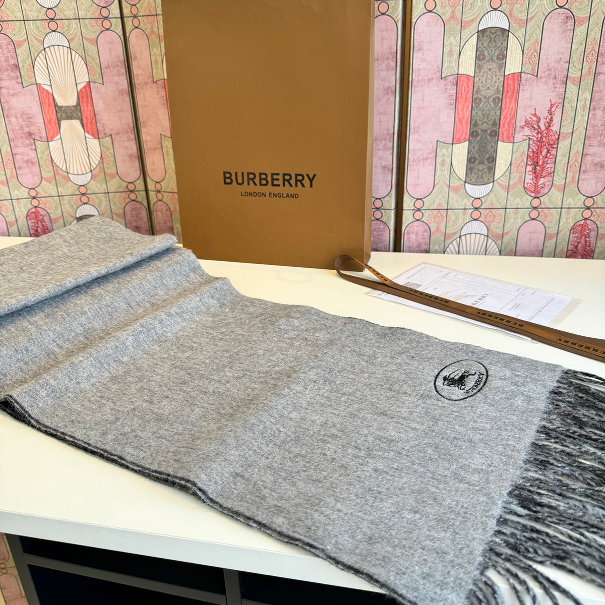 Burberry reversible two-tone wool scarf featuring a circular logo design, crafted from a cotton-wool blend