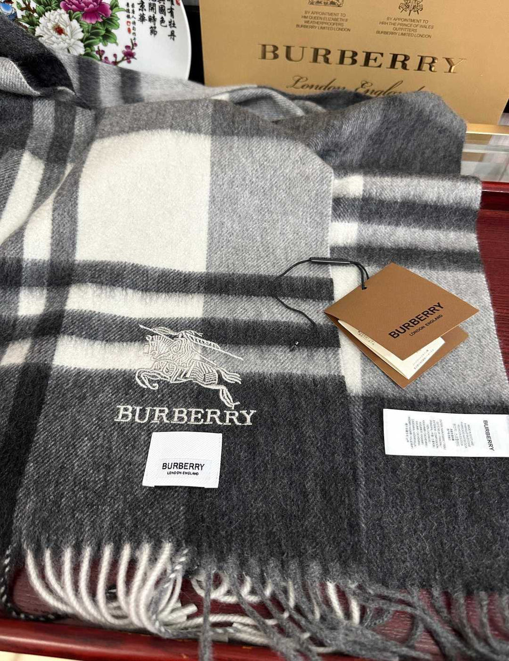 Burberry reversible two-tone wool scarf featuring a circular logo design, crafted from a cotton-wool blend