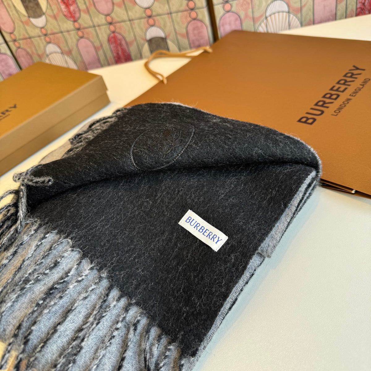 Burberry reversible two-tone wool scarf featuring a circular logo design, crafted from a cotton-wool blend