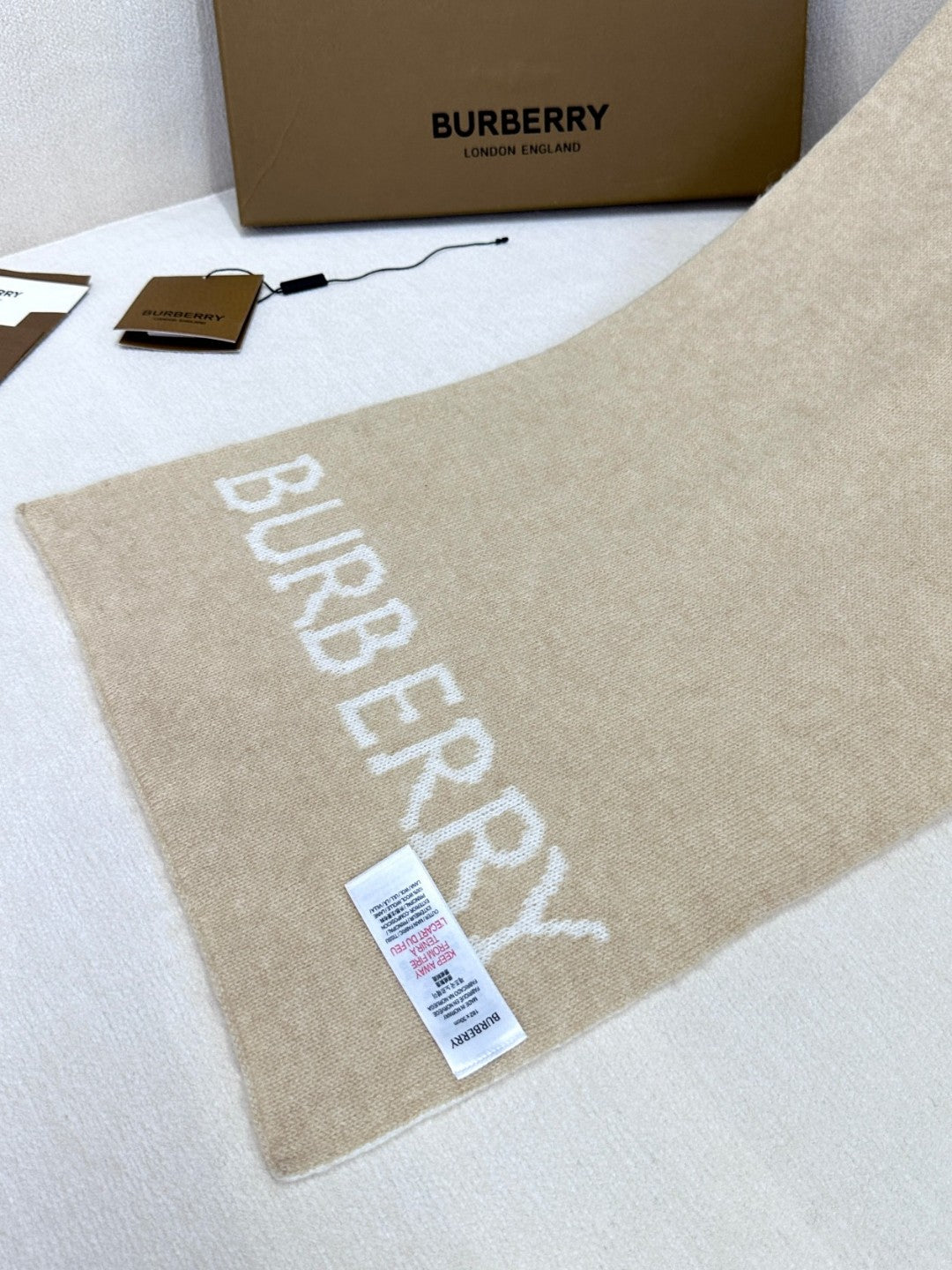 Burberry reversible two-tone wool scarf featuring a circular logo design, crafted from a cotton-wool blend