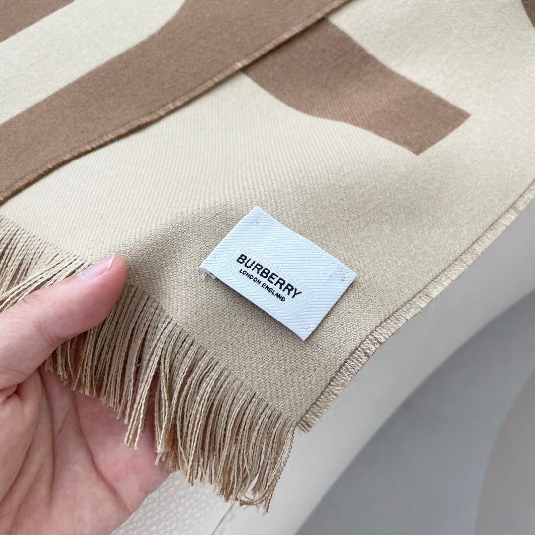 Burberry reversible two-tone wool scarf featuring a circular logo design, crafted from a cotton-wool blend