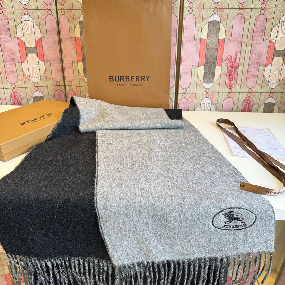 Burberry reversible two-tone wool scarf featuring a circular logo design, crafted from a cotton-wool blend