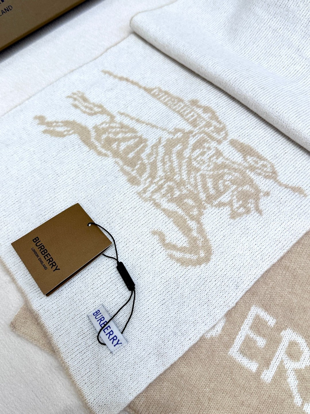Burberry reversible two-tone wool scarf featuring a circular logo design, crafted from a cotton-wool blend