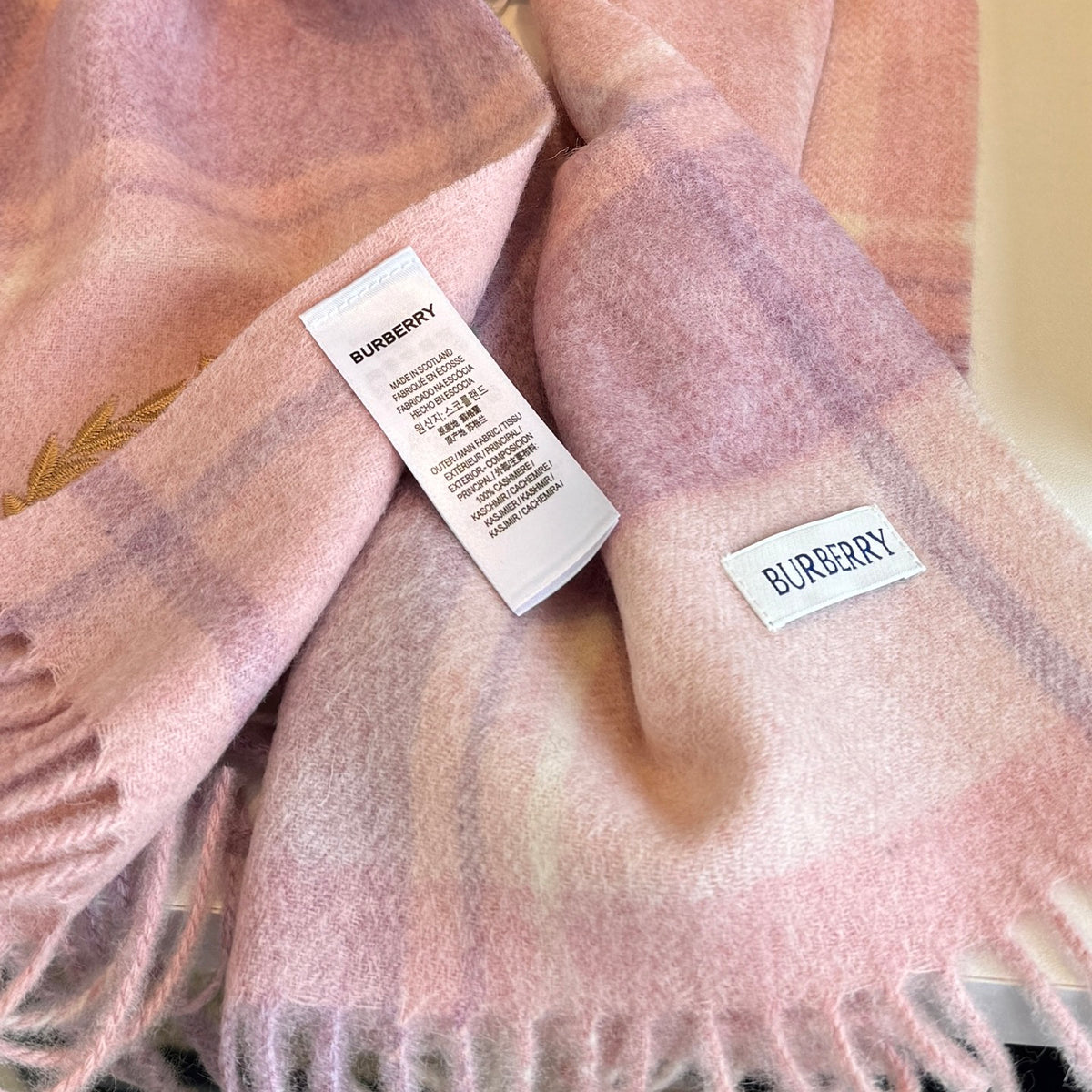 Burberry reversible two-tone wool scarf featuring a circular logo design, crafted from a cotton-wool blend