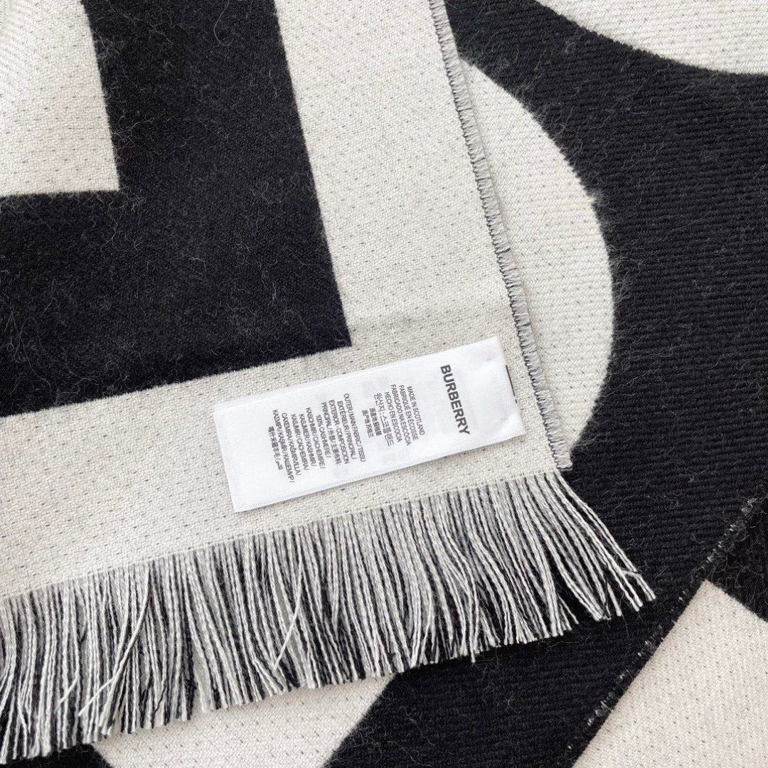 Burberry reversible two-tone wool scarf featuring a circular logo design, crafted from a cotton-wool blend